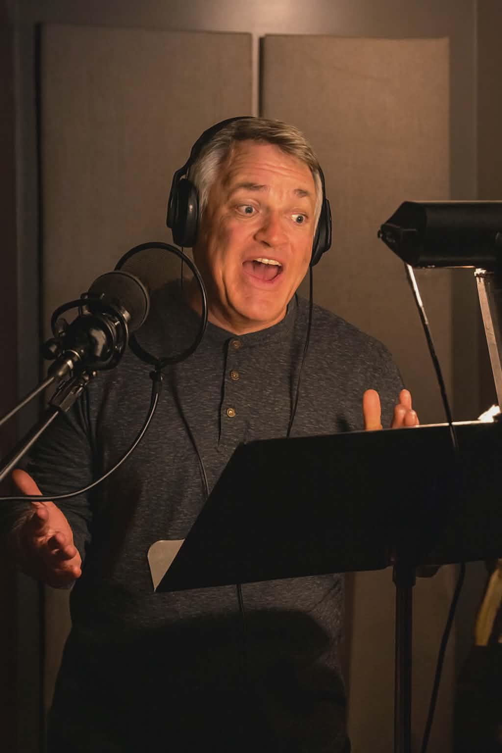 Bill recording voiceover in a professional booth